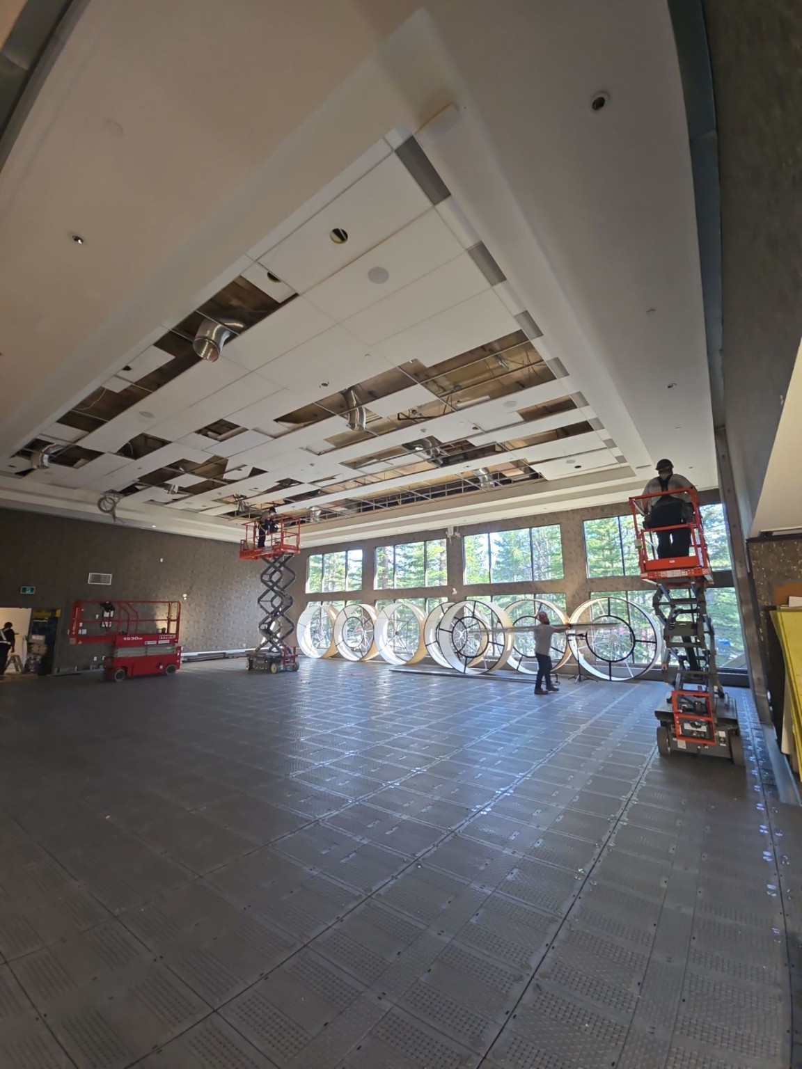 Ceiling panel installation in progress at G7 Kananaskis
